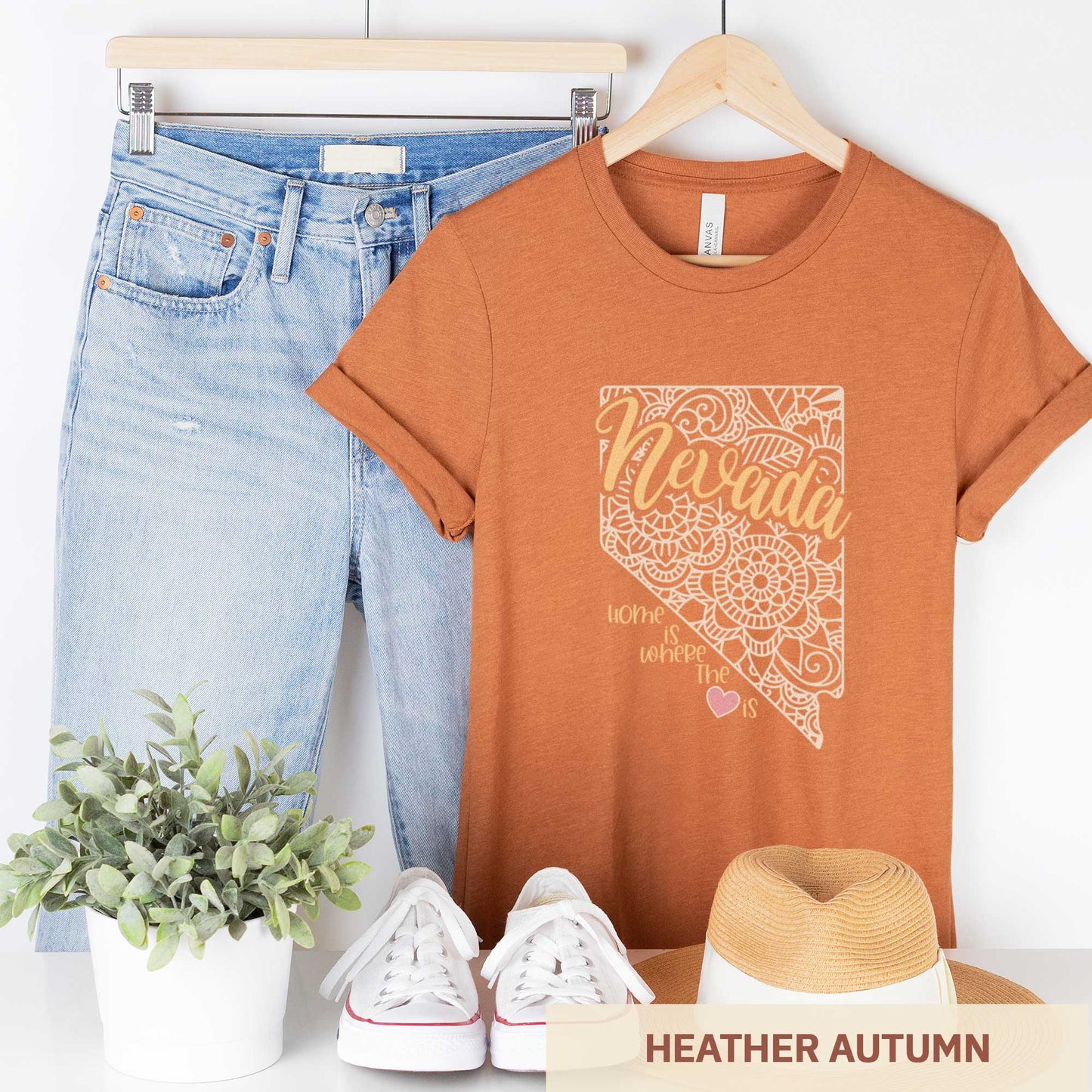 A hanging heather autumn Bella Canvas t-shirt featuring a mandala in the shape of Nevada with the words home is where the heart is.