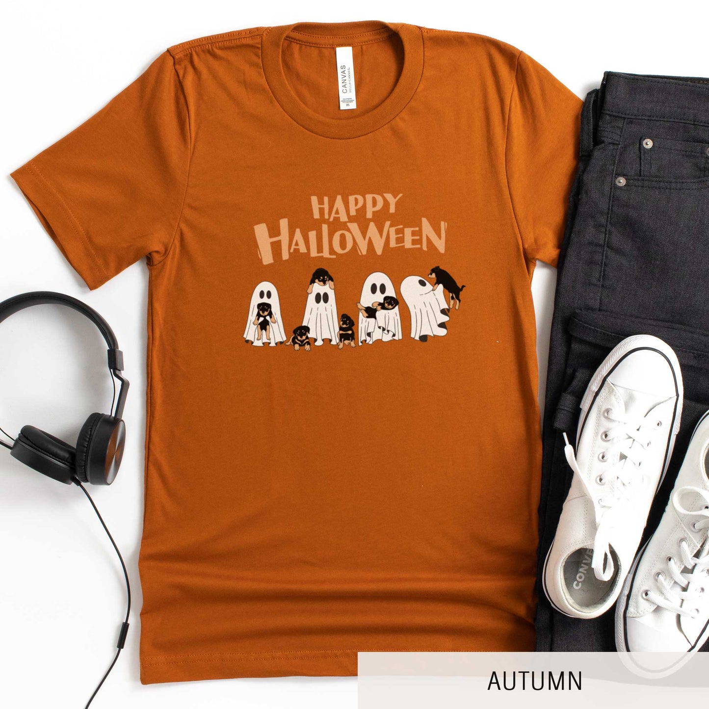 An autumn Bella Canvas t-shirt featuring four ghosts holding Beauceron puppies.