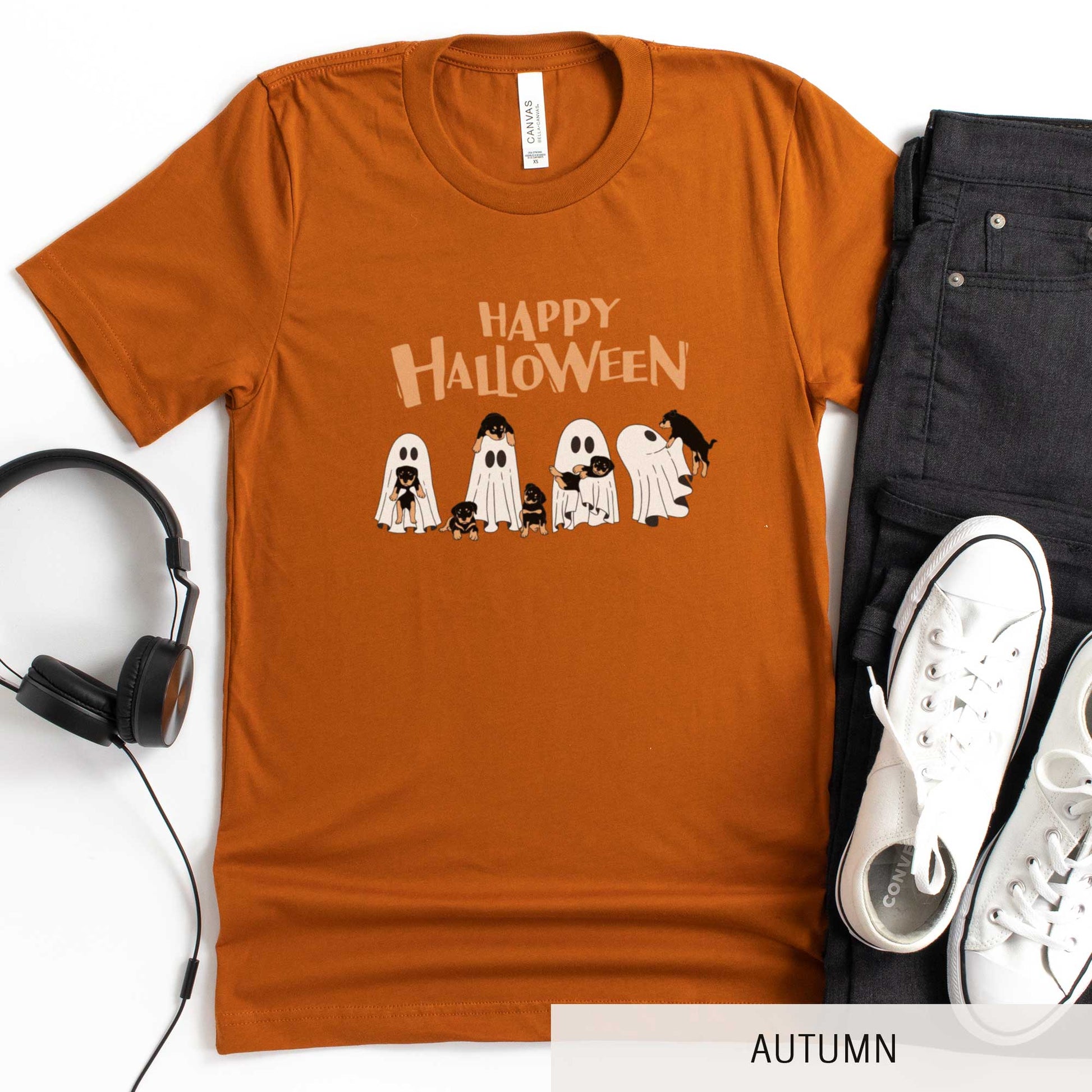 An autumn Bella Canvas t-shirt featuring four ghosts holding Beauceron puppies.