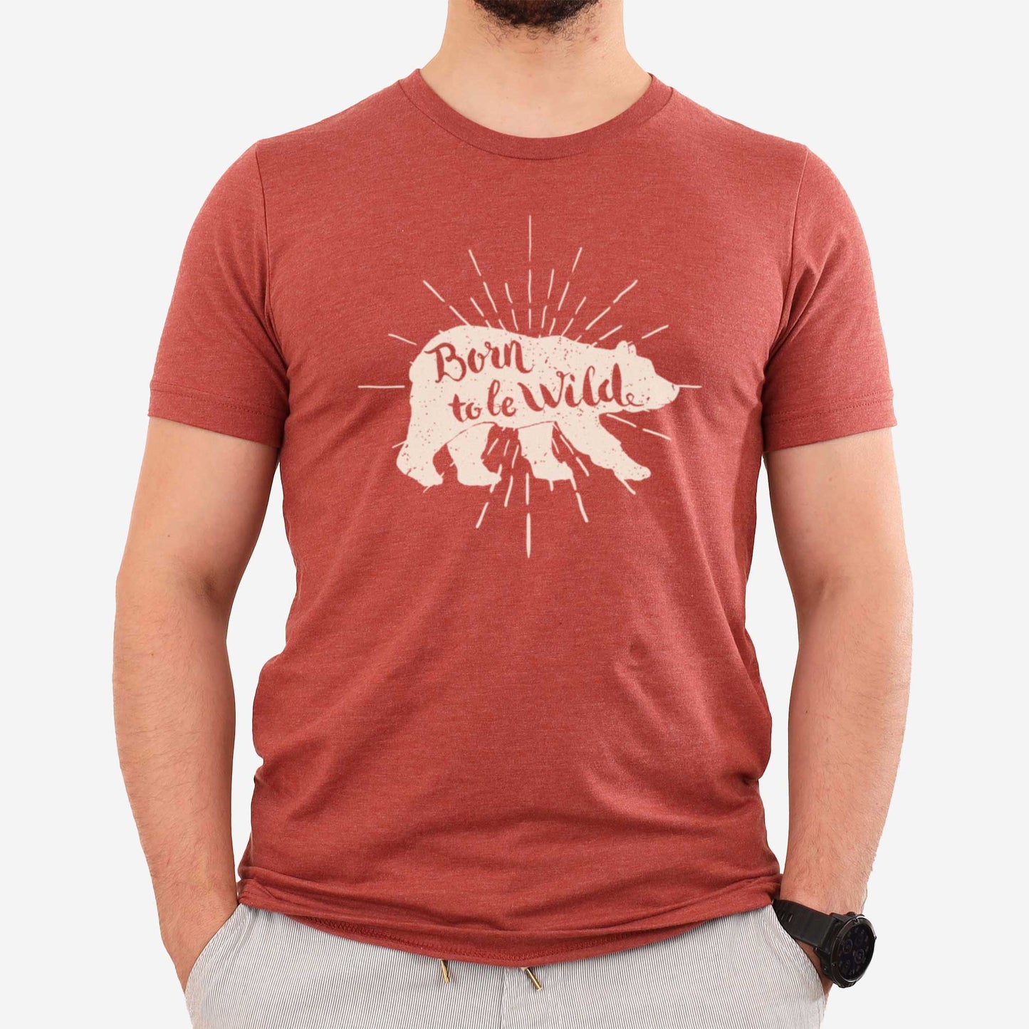 A man wearing a heather clay Bella Canvas t-shirt featuring a bear and the words born to be wild.