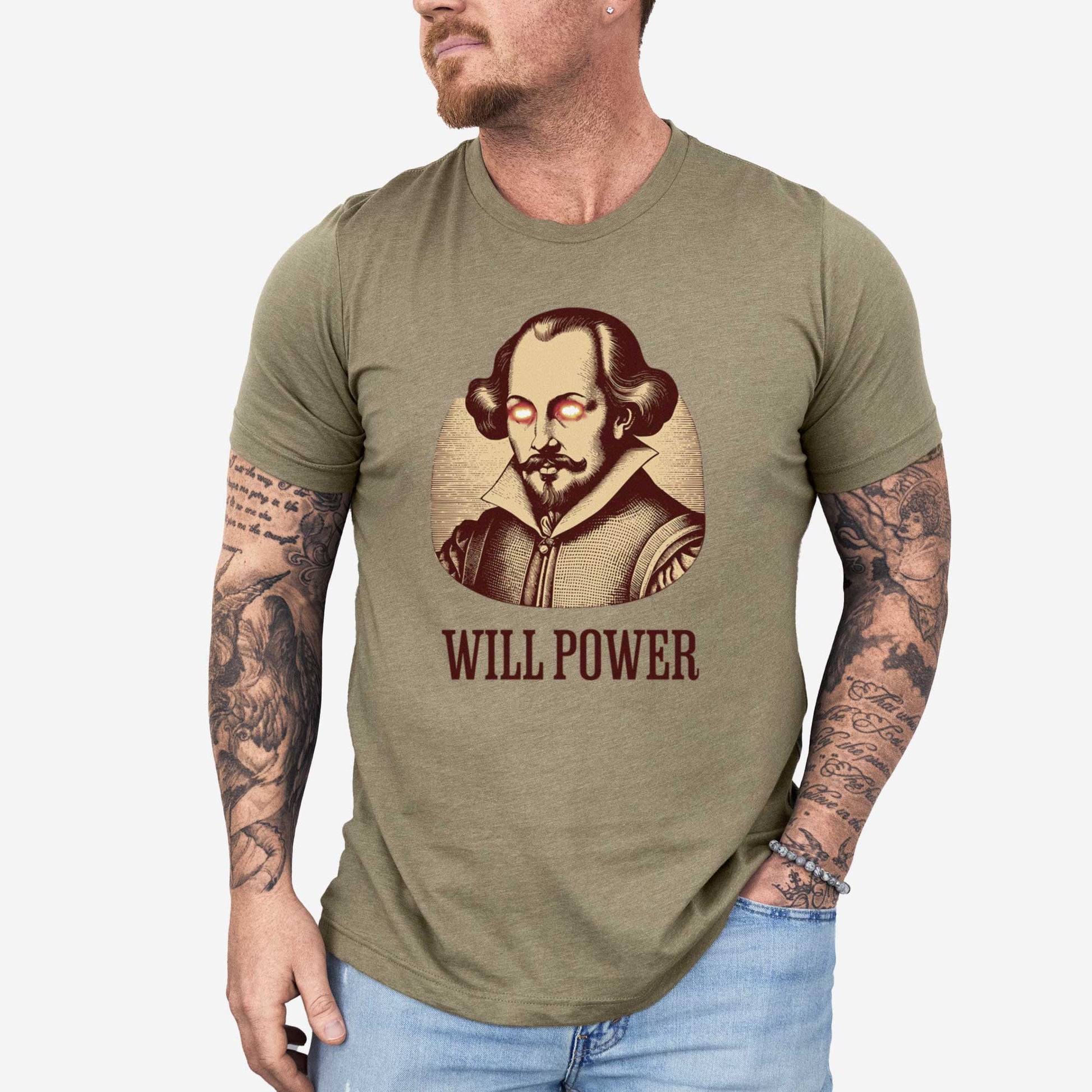 A man wearing a heather olive Bella Canvas t-shirt featuring a woodcut of William Shakespeare with glowing superhero eyes and the words Will Power.