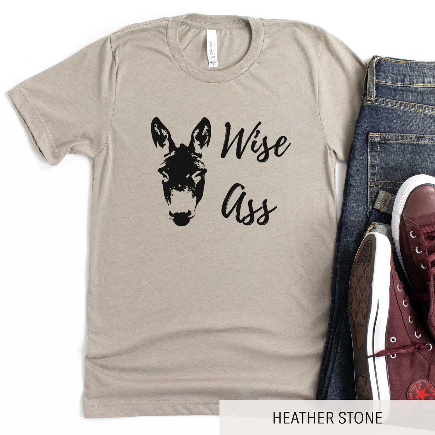 A heather stone Bella Canvas t-shirt featuring a donkey and the words wise ass.