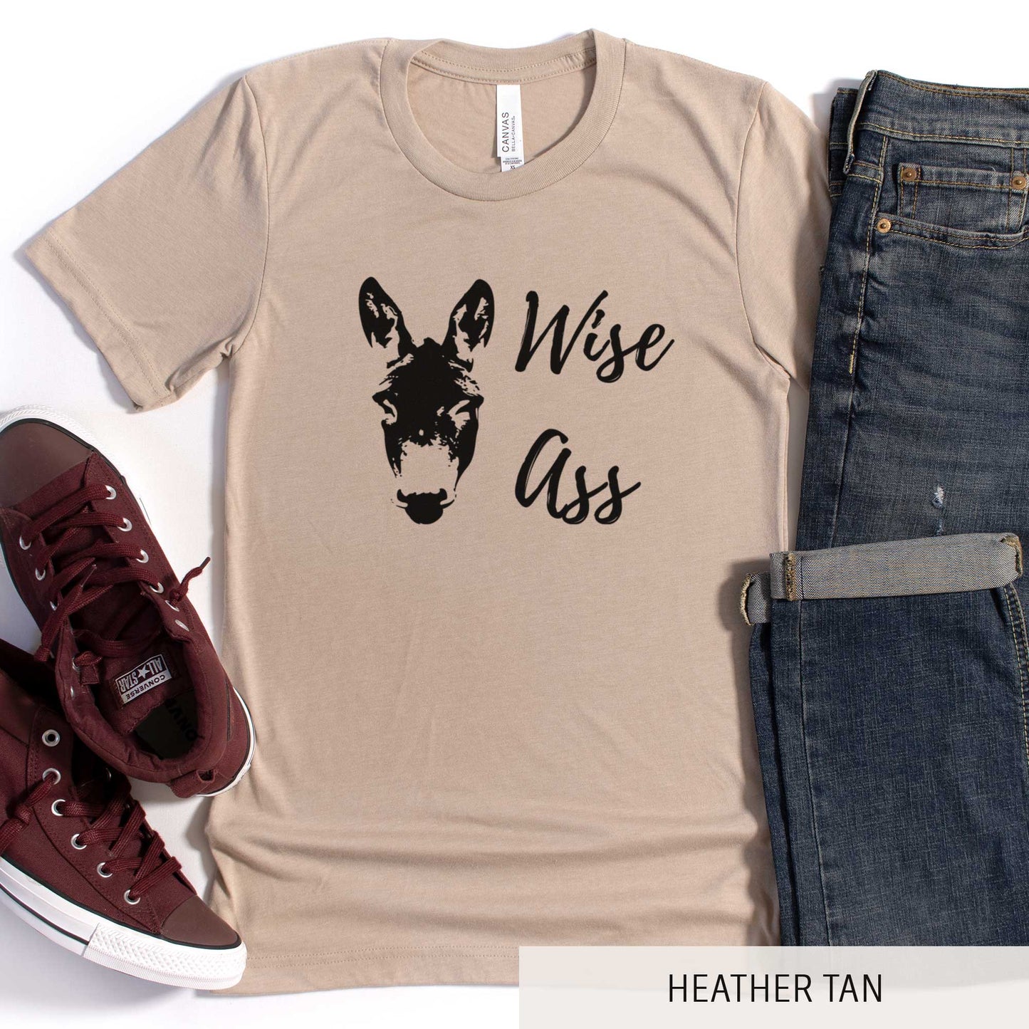 A heather tan Bella Canvas t-shirt featuring a donkey and the words wise ass.