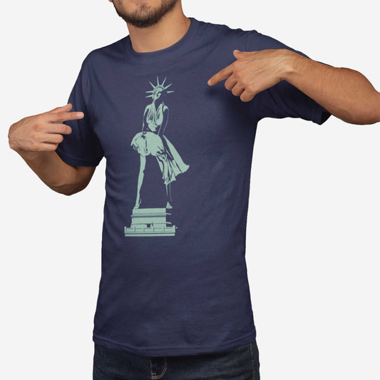 A man wearing a navy Bella Canvas t-shirt featuring the Statue of Liberty dressed up as Marilyn Monroe's character from the Seven Year Itch.
