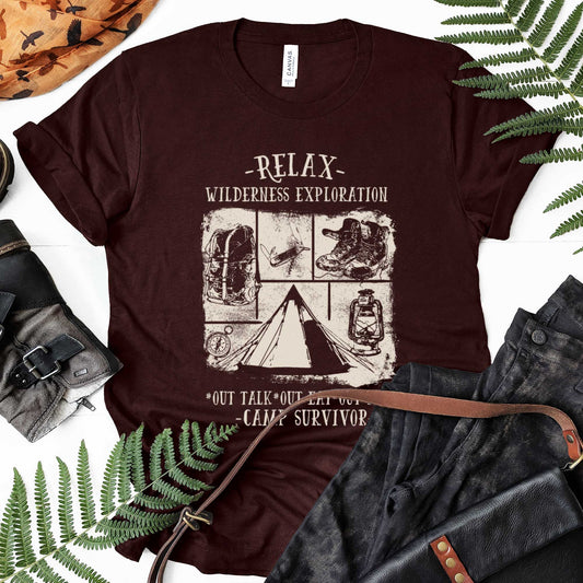 An oxblood black Bella Canvas t-shirt featuring camping images with the words relax wilderness exploration, out talk, out eat, out play, camp survivor.