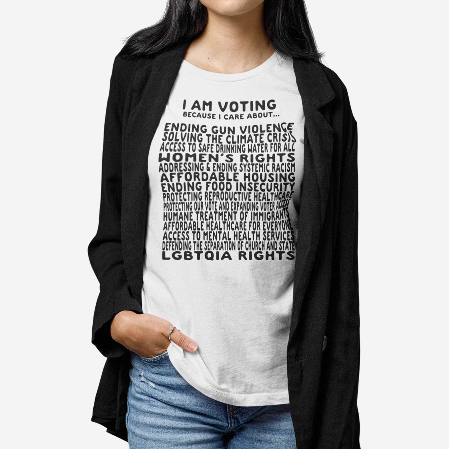 A woman wearing a white Bella Canvas t-shirt featuring a long list of issues she is voting on.