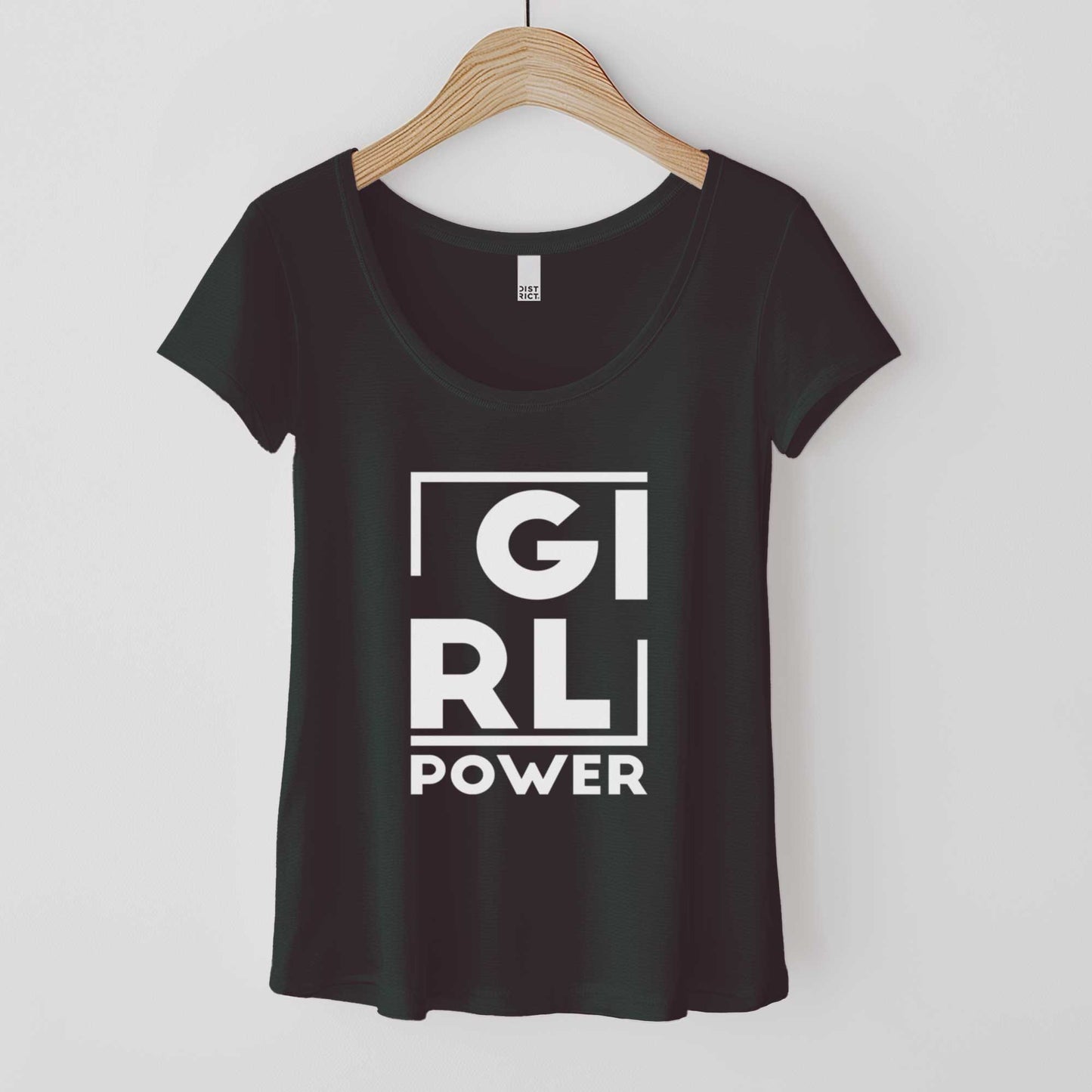 A hanging black District 7501 scoop neck t-shirt featuring the words girl power.