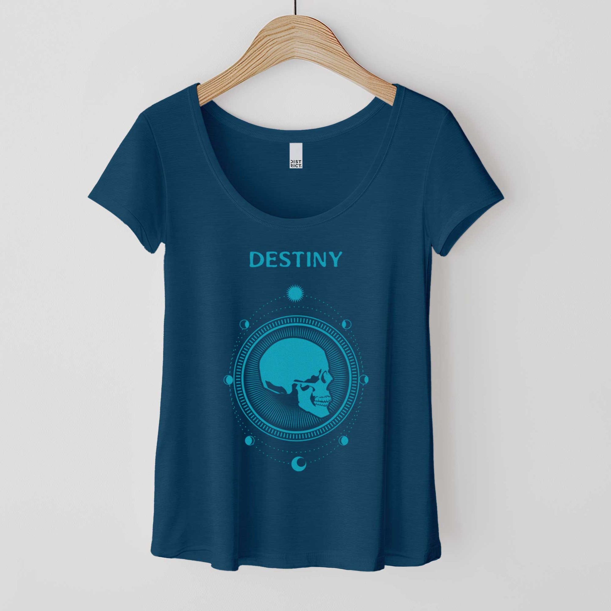 A hanging heathered neptune blue District 7501 scoop neck t-shirt featuring a profile of a skull surrounded by phases of the moon in a circle and the word destiny above it.