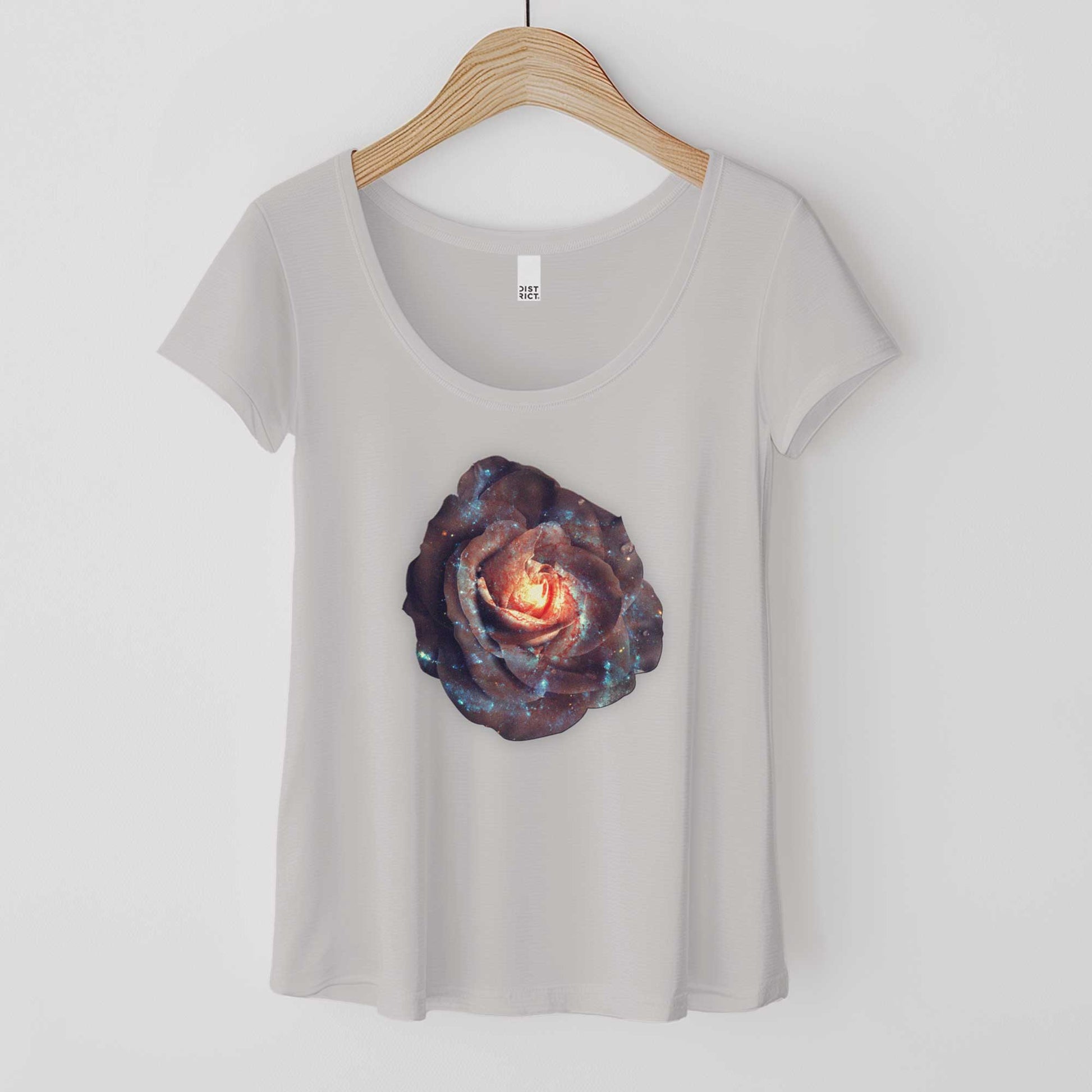 A hanging silver mist District 7501 scoop neck t-shirt featuring a celestial image of the galaxy shaped into a rose.