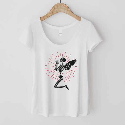 A hanging white District 7501 scoop neck t-shirt featuring a kneeling skeleton with wings in prayer.