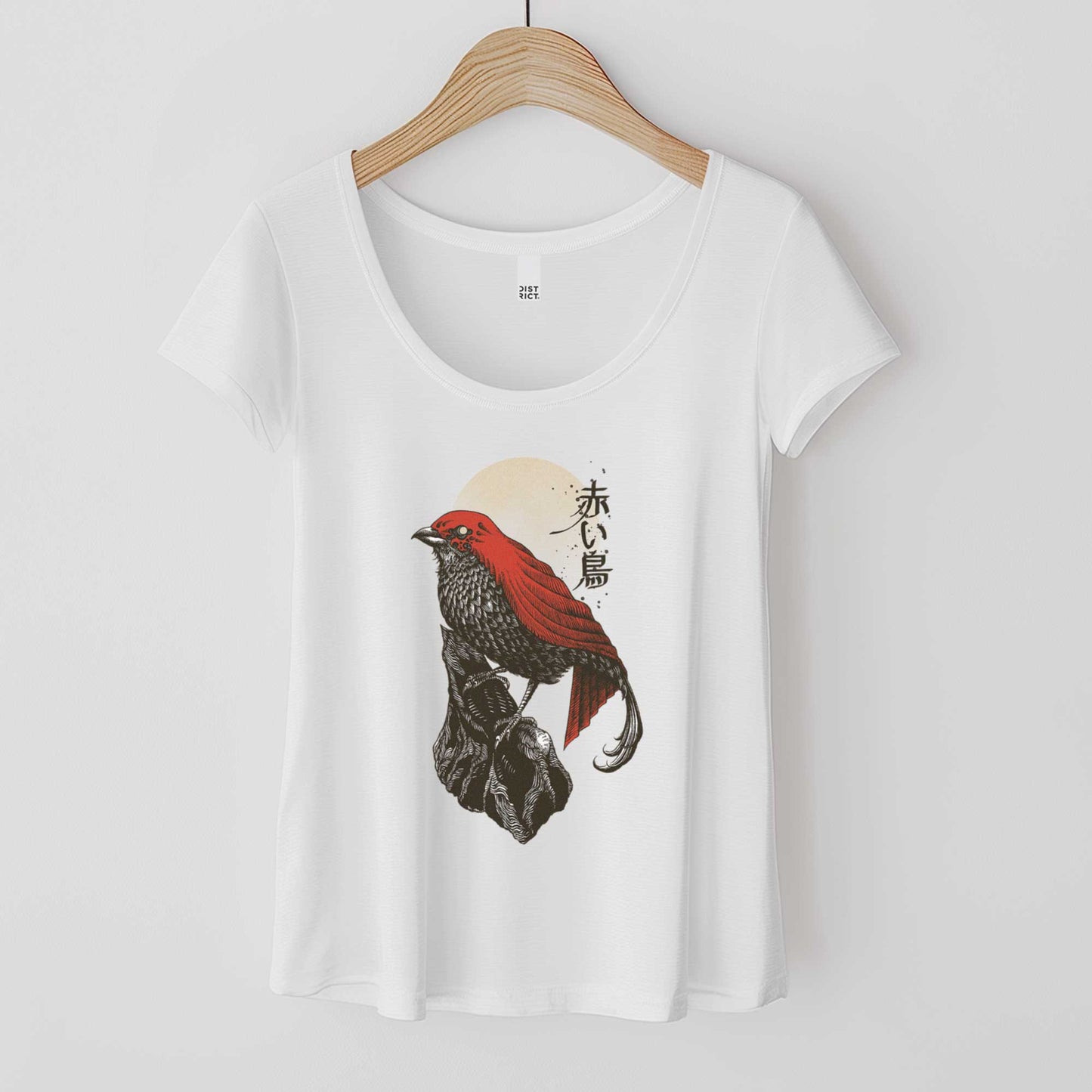 A hanging white District scoop neck t-shirt featuring a detailed illustration of a red bird.