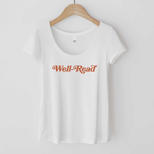 A white District 7501 scoop neck t-shirt featuring the words well-read in clay colored font.