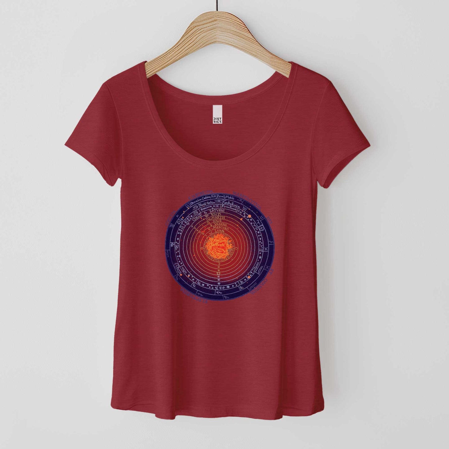 A hanging heathered red District 7501 scoop neck t-shirt featuring a colorized version of a 1539 schematic of the universe by Peter Apian.