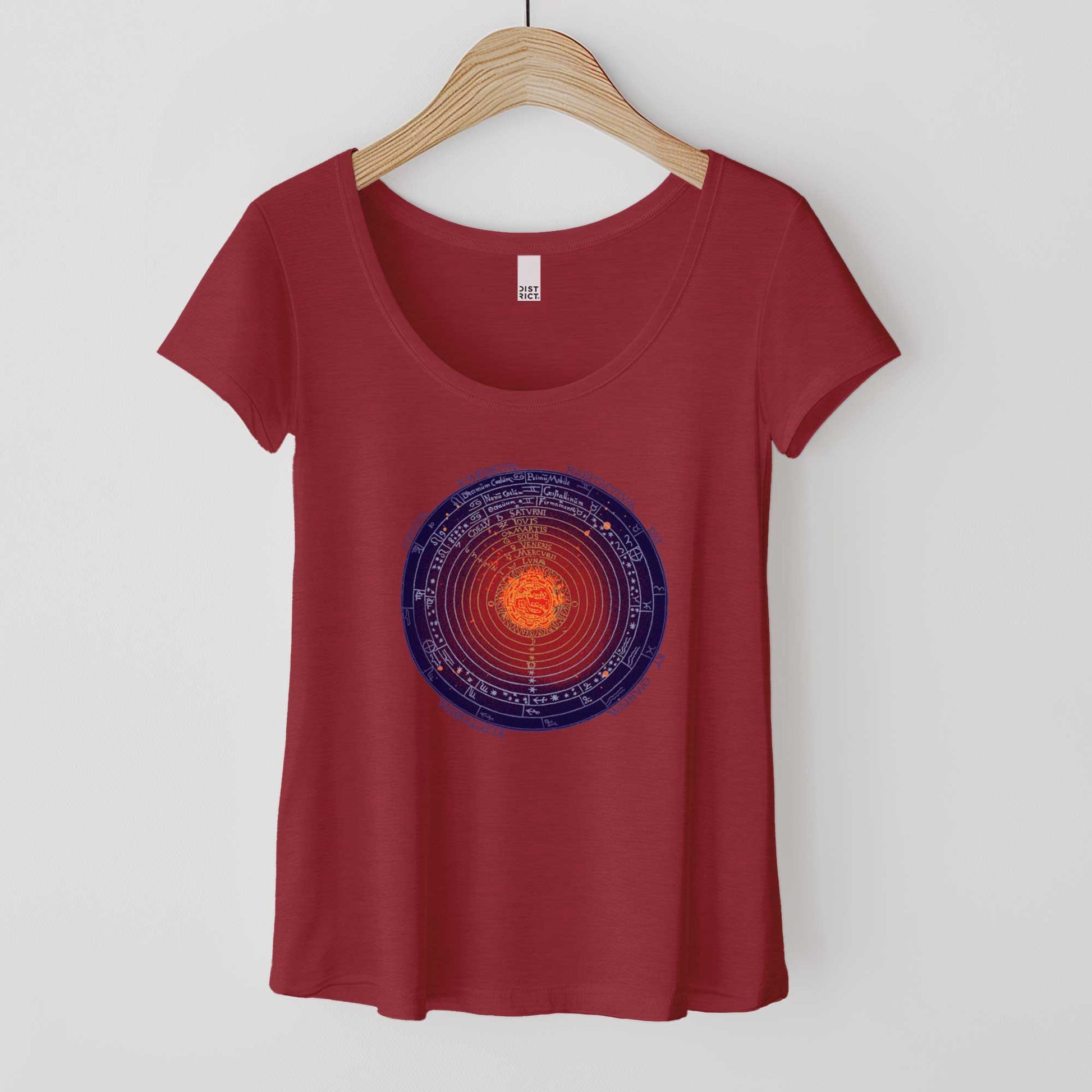 A hanging heathered red District 7501 scoop neck t-shirt featuring a colorized version of a 1539 schematic of the universe by Peter Apian.