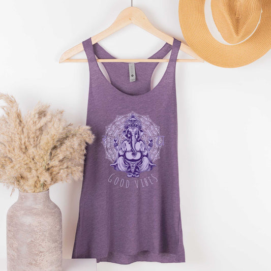 A hanging vintage purple Next Level racerback tank top featuring the Hindu deity Ganesha surrounded by a mandala and the words good vibes.